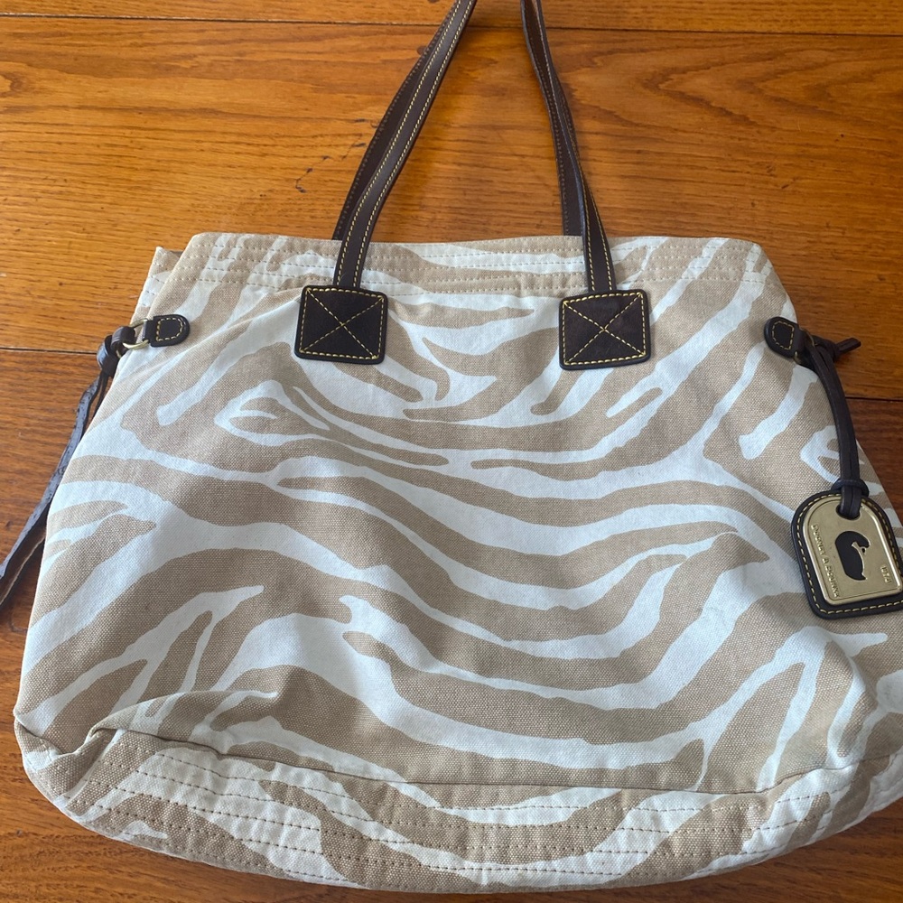 Dooney and Bourke animal print tote.  Tan and white outside with pink interior.